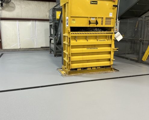 Beverage plant flooring installation around industrial equipment