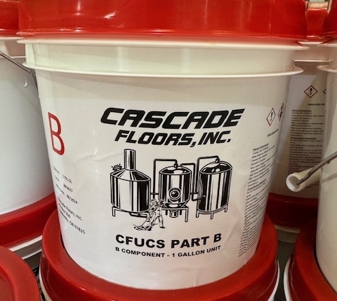 Containers of Cascade Floors In House proprietary epoxy flooring system for commercial use