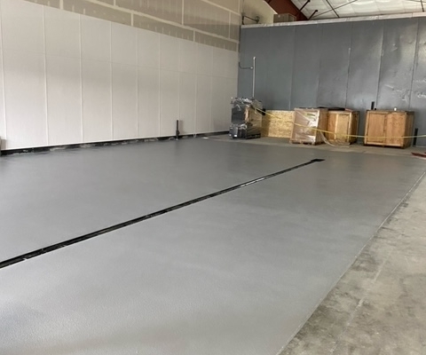 Epoxy flooring installation at Grains of Wrath Brewery with center drain